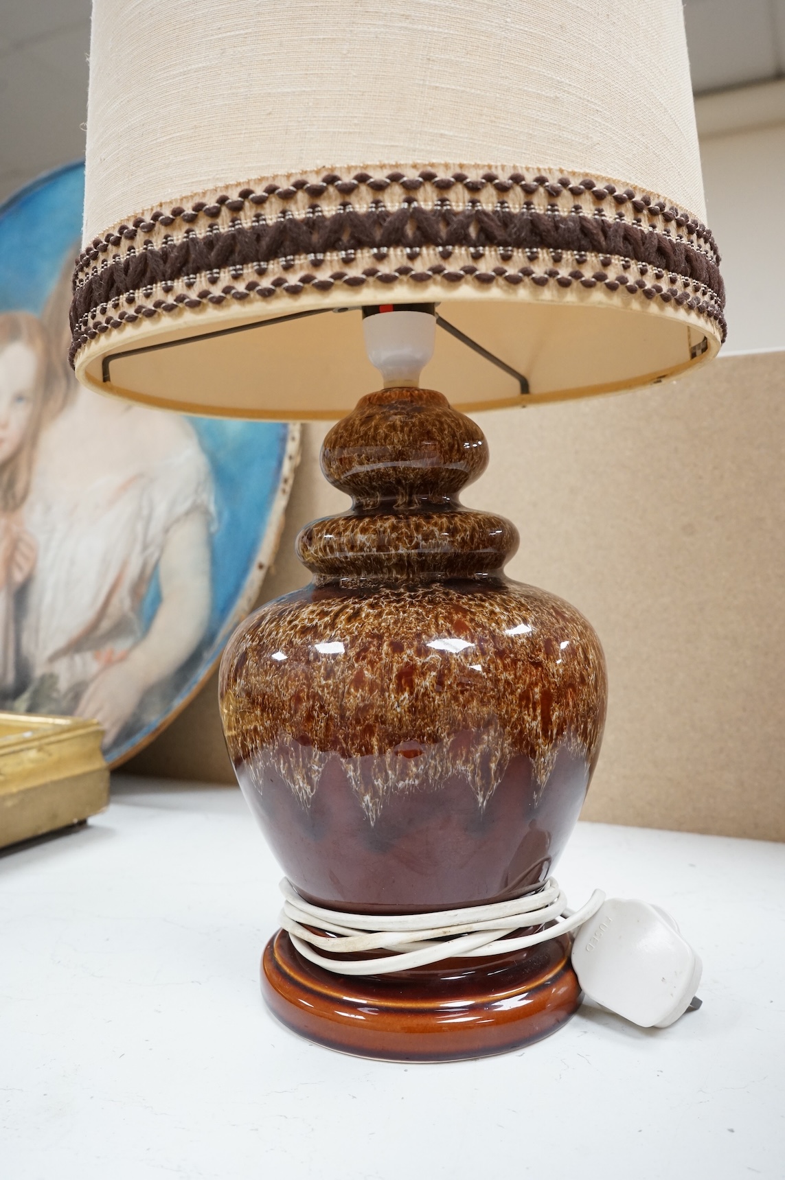 A mid century modern brown glazed ceramic table lamp and brown braided shade, 84cm including shade